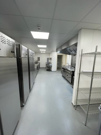 Modern commercial kitchen with stainless steel appliances and a spacious, clean layout.